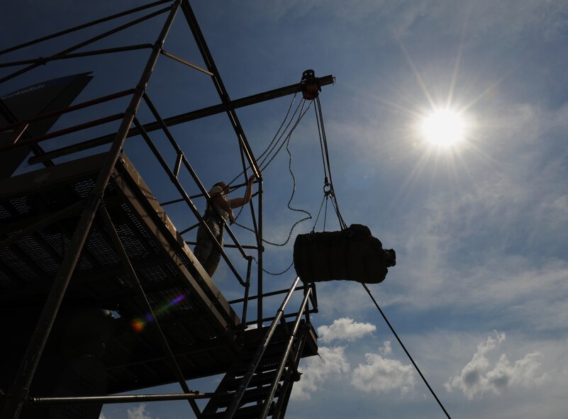 Staff Sgt. Richard Sturm, 20th Aircraft Maintenance Unit crew chief, hoists a chute bag on Barksdale Air Force Base, La., May 28, 2013. The chute bag holds the large parachute that is used to slow down a rapidly moving B-52H Stratofortress during landing. (U.S. Air Force photo/Airman 1st Class Benjamin Gonsier)