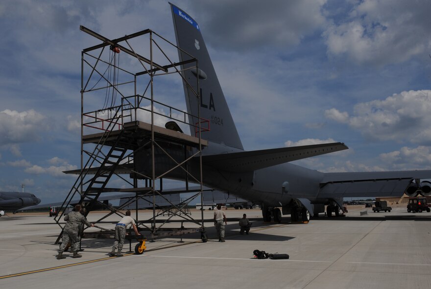 Crew chiefs from the 20th Aircraft Maintenance Unit push a drag chute behind a B-52H Stratofortress on Barksdale Air Force Base, La., May 28, 2013. The stand provides Airmen stability and convenience when packing the chute equipment into the aircraft. (U.S. Air Force photo/Airman 1st Class Benjamin Gonsier)