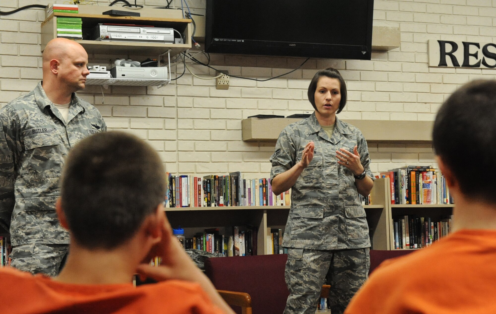 Master Sgt. Kevin Butler, 618th Air Operations Center signature management manger, and Airman 1st Class Joanne Griffin, U.S. Band of Mid-America vocalist, tell the children of the Haller House Madison County Detention Center in Edwardsville, Ill., about themselves May 22, 2013. Most of the children are having trouble at home, or at school. Some are in alternative schools, some are chronically truant and some are trying to get their GED.  The kids are accused of a range of offenses, from shoplifting to domestic battery to murder. (U.S Air Force photo/Senior Airman Jake Eckhardt)