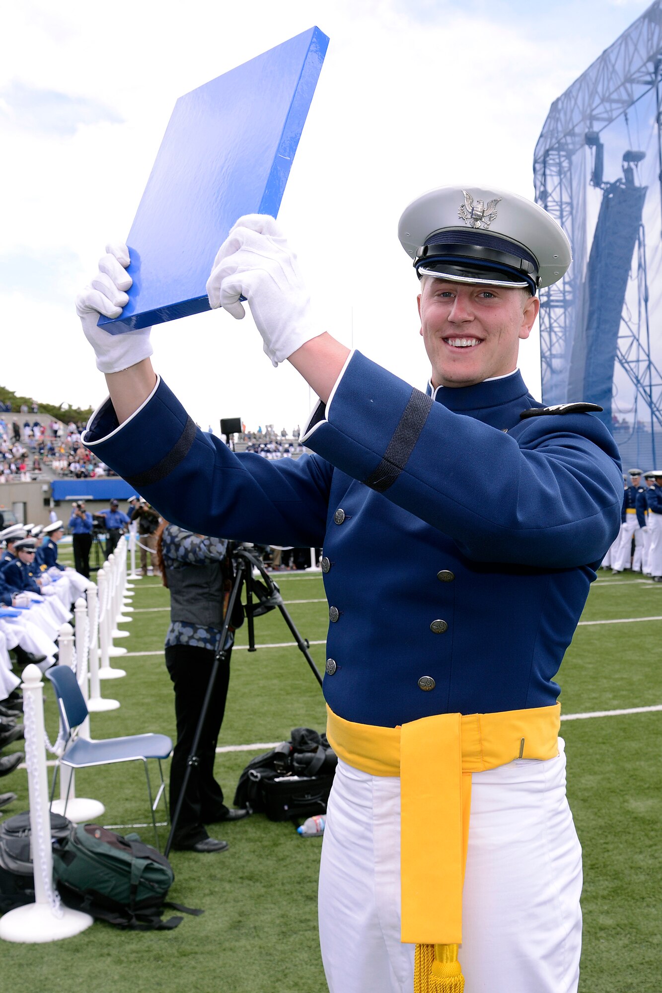 Cadet Alex Means raises his diploma at the U.S. Air Force Academy Class of 2013 commencement ceremony at the Academy's Falcon Stadium in Colorado Springs, Colo. May 29, 2013.  1,024 graduates will be commissioned today.  (U.S. Air Force Photo by Mike Kaplan/Released)