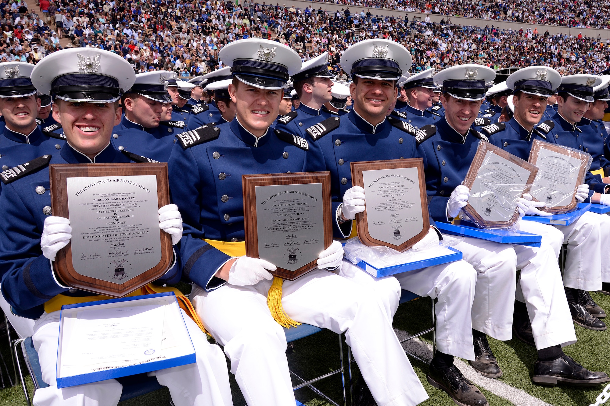 Cadet Zebulon Hanley (left) and classmates hold their Bachelor of Science degrees at the U.S. Air Force Academy Class of 2013 commencement ceremony at the Academy's Falcon Stadium in Colorado Springs, Colo. May 29, 2013.  Hanley is the top graduate in a class of 1,024 graduates.  (U.S. Air Force Photo by Mike Kaplan/Released)