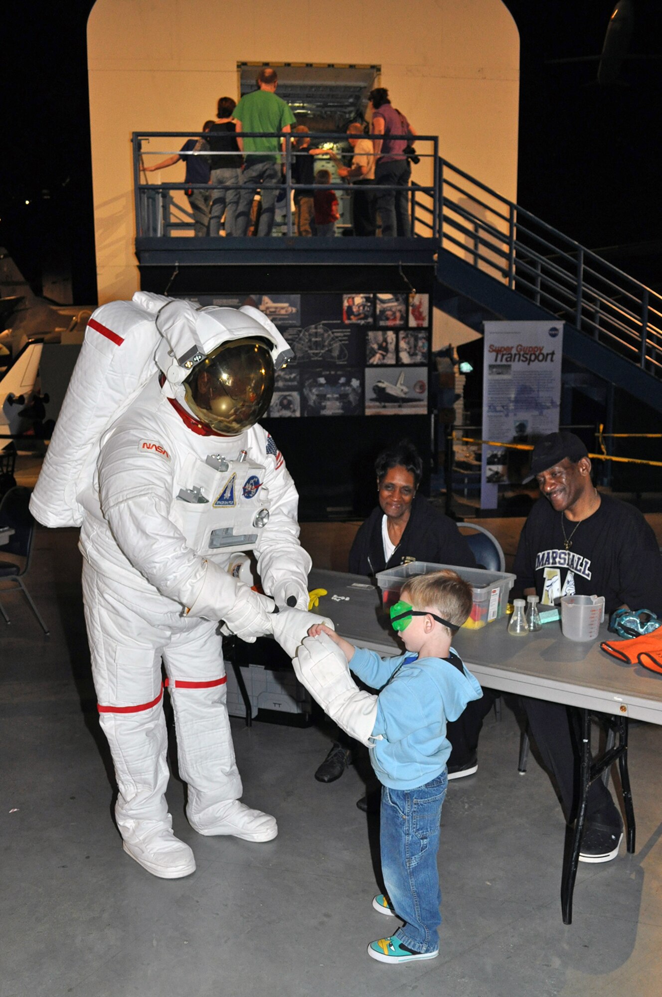 DAYTON, Ohio (05/2013) -- A young visitor gets a little help from an astronaut during Space Fest on May 4 at the National Museum of the U.S. Air Force. (U.S. Air Force photo by Garry Guthrie)
