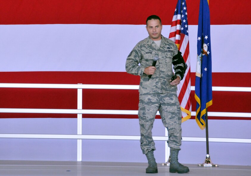 Tech. Sgt. John Griffin recounts his motorcycle accident, explaining how his use of personal protective equipment saved his life, during a commander's call at Homestead Air Reserve Base, Fla., May 5. Among his many injuries, Griffin suffered a shattered left elbow, a fractured left shoulder blade, and two fractures on his lower back as a result of the accident in April. Both Griffin and his doctor credit his use of personal protective equipment for saving his life. Griffin is a traditional reservist with the 482nd Maintenance Squadron at Homestead ARB. (U.S. Air Force photo/Senior Airman Nicholas Caceres)