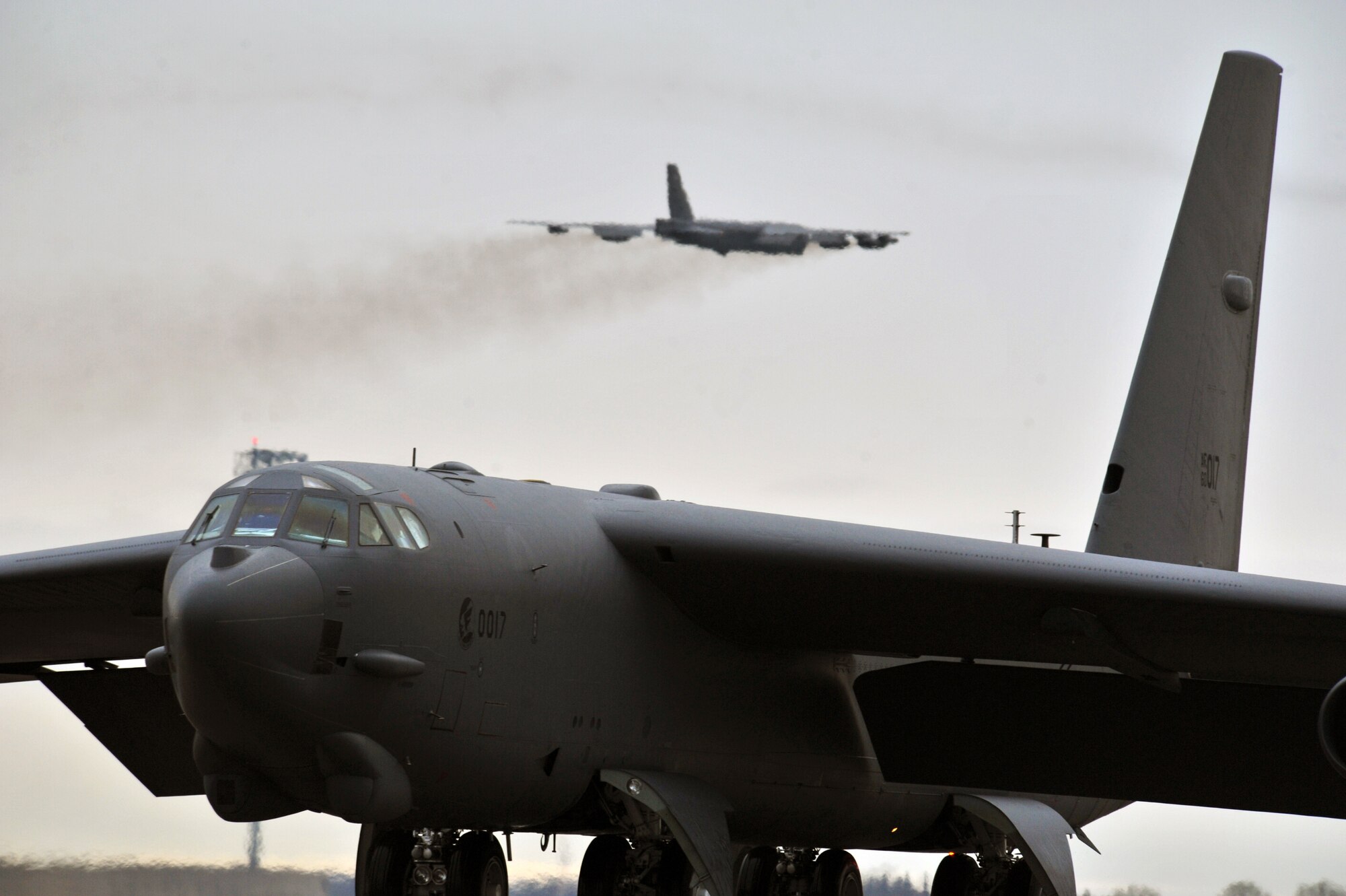 MINOT AIR FORCE BASE, N.D. – A B-52H Stratofortress is seen in flight as another taxies onto the runway during a training exercise here, May 21. Air Force Global Strike Command routinely conducts training operations and exercises to ensure its forces can perform their mission when called upon at any time. (U.S. Air Force photo/Senior Airman Brittany Y. Auld)