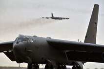 MINOT AIR FORCE BASE, N.D. – A B-52H Stratofortress is seen in flight as another taxies onto the runway during a training exercise here, May 21. Air Force Global Strike Command routinely conducts training operations and exercises to ensure its forces can perform their mission when called upon at any time. (U.S. Air Force photo/Senior Airman Brittany Y. Auld)