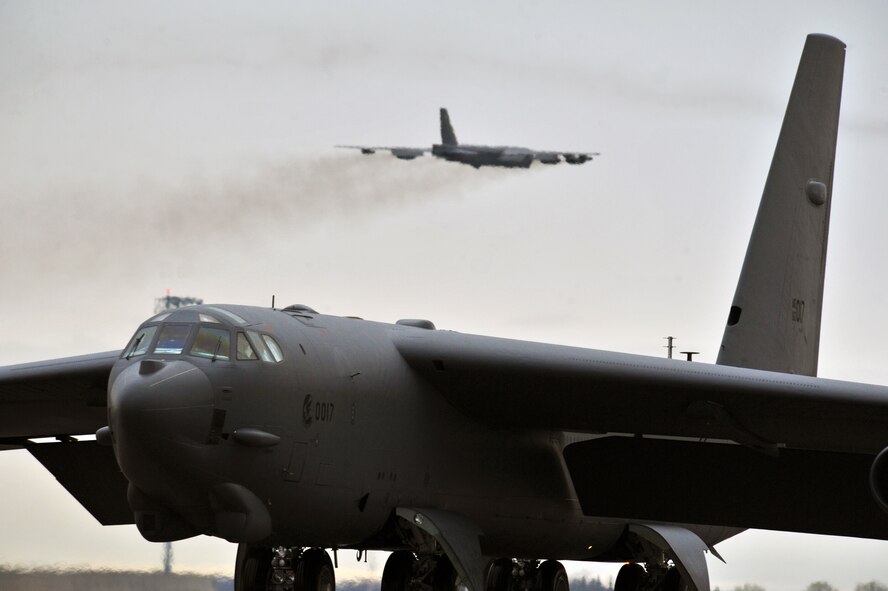 MINOT AIR FORCE BASE, N.D. – A B-52H Stratofortress is seen in flight as another taxies onto the runway during a training exercise here, May 21. Air Force Global Strike Command routinely conducts training operations and exercises to ensure its forces can perform their mission when called upon at any time. (U.S. Air Force photo/Senior Airman Brittany Y. Auld)