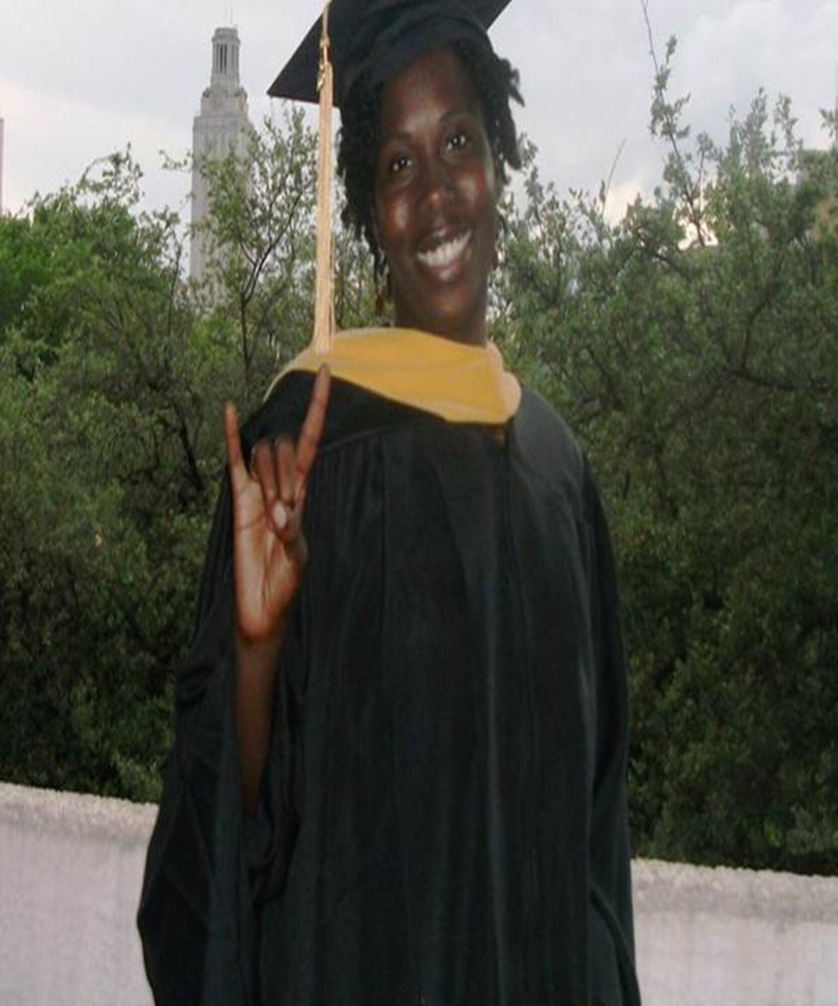 United States Air Force Capt. Derandoria Young, 49th Medical Operations Squadron, flashes the "Longhorn sign" on her graduation day from the University of Texas School of Social Work in 2010. Young served 11 years as an enlisted member before commissioning an officer.  (photo courtesy of Capt. Derandoria Young/Released)