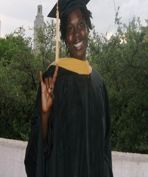 United States Air Force Capt. Derandoria Young, 49th Medical Operations Squadron, flashes the "Longhorn sign" on her graduation day from the University of Texas School of Social Work in 2010. Young served 11 years as an enlisted member before commissioning an officer.  (photo courtesy of Capt. Derandoria Young/Released)