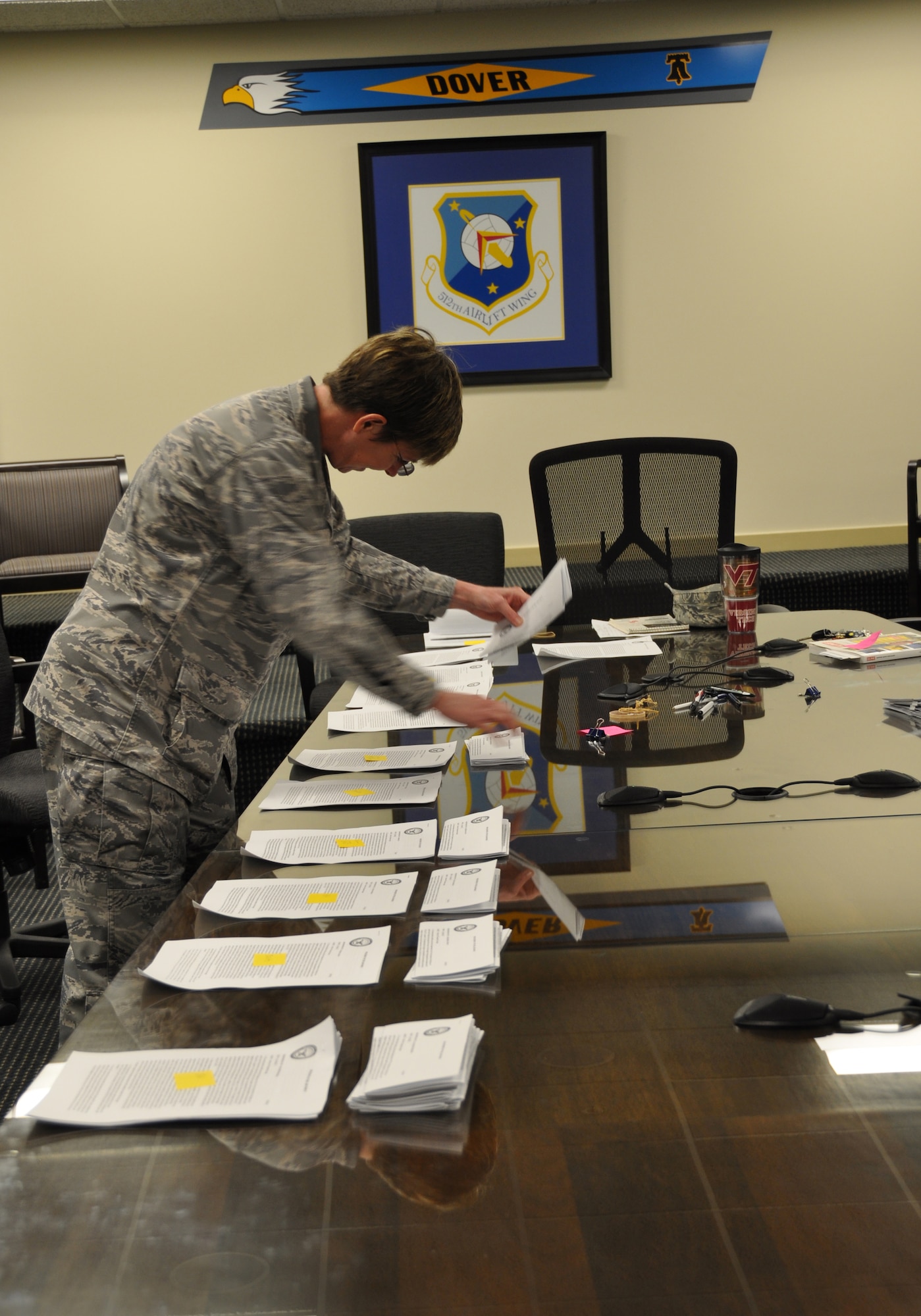 Col. Gretchen M. Wiltse, 512th Mission Support Group commander, organizes notices of proposed furlough May 29, 2013, in preparation for their dissemination to the 250 federal employees assigned to the 512th Airlift Wing, Dover Air Force Base, Del. The memorandum included furlough plans and instructions on submitting responses to the notification within seven days. (U.S. Air Force photo/Master Sgt. Veronica Aceveda)