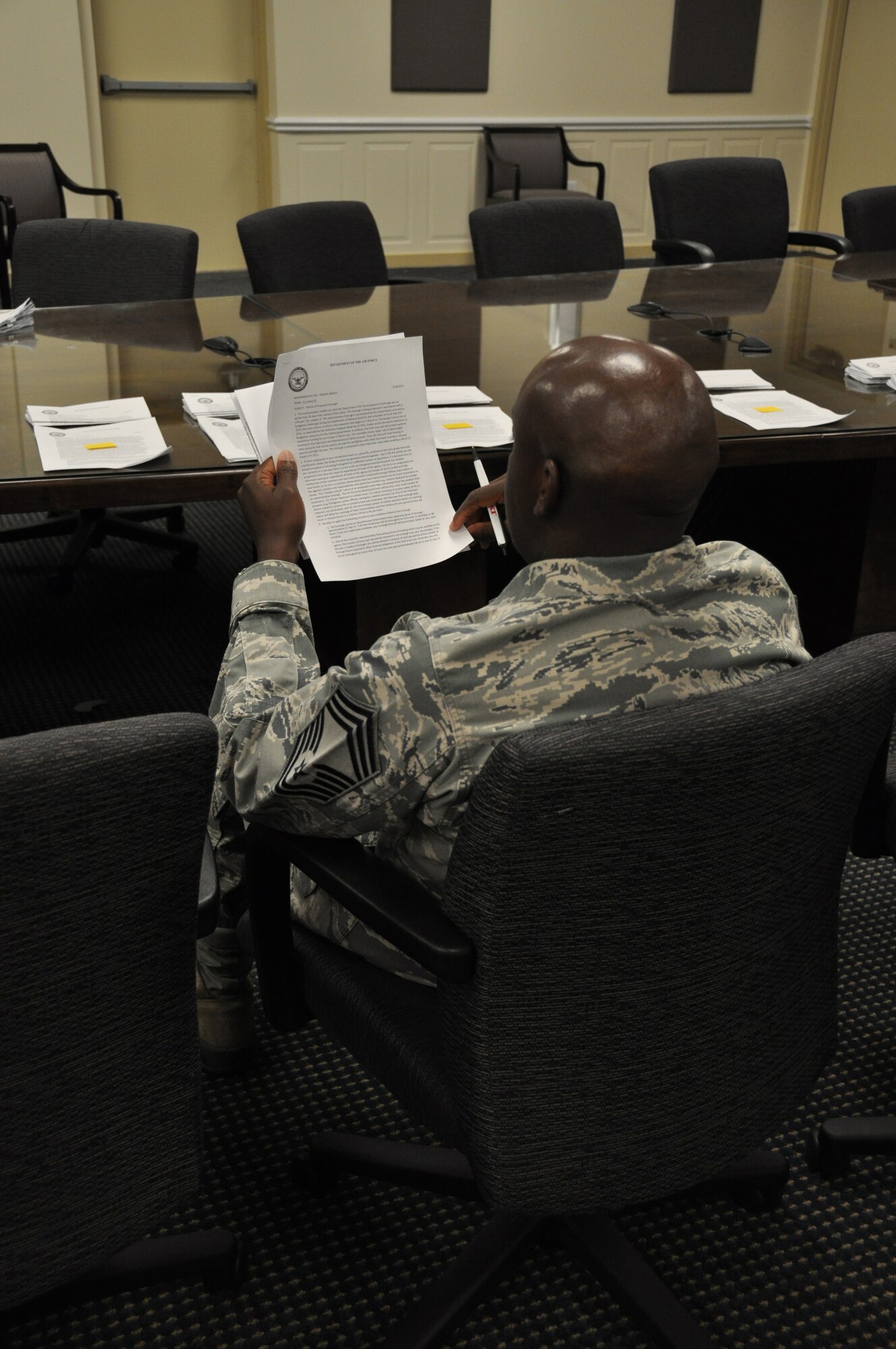 An air reserve technician assigned to the 512th Airlift Wing reviews the notice of proposed furlough he received May 29, 2013, on Dover Air Force Base, Del. The chief master sergeant is one of 250 512th Airlift Wing federal employees who received the memorandum, which outlined furlough plans from July 8 to September 21, 2013.  (U.S. Air Force photo/Master Sgt. Veronica Aceveda)