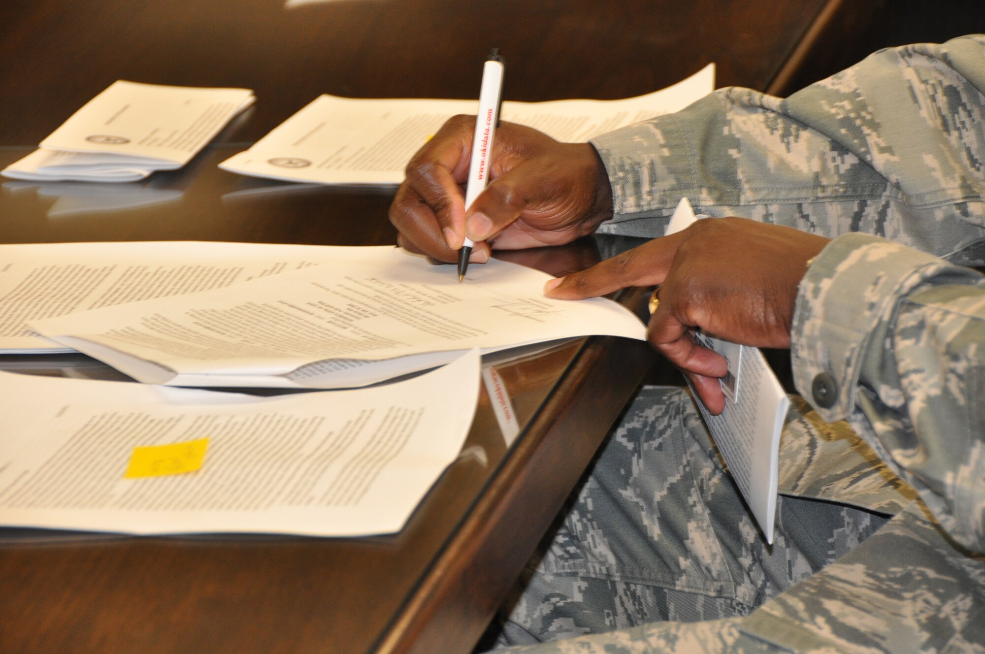 A federal employee assigned to the 512th Airlift Wing, Dover Air Force Base, Del., signs the notice of proposed furlough he received May 29, 2013. The Reserve wing’s 250 civilian employees received a copy of the memorandum for themselves after signing and returning the original notification to wing leadership. (U.S. Air Force photo/Master Sgt. Veronica Aceveda)   