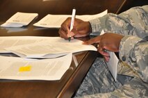 A federal employee assigned to the 512th Airlift Wing, Dover Air Force Base, Del., signs the notice of proposed furlough he received May 29, 2013. The Reserve wing’s 250 civilian employees received a copy of the memorandum for themselves after signing and returning the original notification to wing leadership. (U.S. Air Force photo/Master Sgt. Veronica Aceveda)   