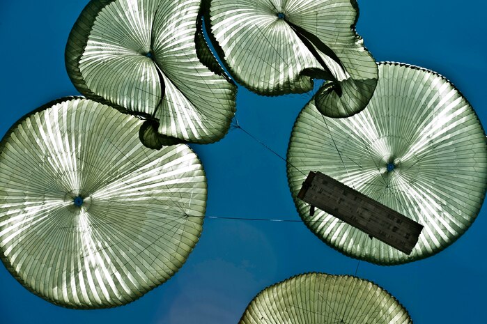 U.S. Air Force equipment from the 820th RED HORSE Squadron, descends for support during a previous Mobility Air Force Exercise May 23, 2012, over the Nevada Test and Training Range. Members of the 820th RED HORSE Airborne Squadron are capable of parachuting into heavily damaged airfields and rapidly returning them to service for use by friendly forces. (U.S. Air Force photo by Senior Airman Daniel Hughes)