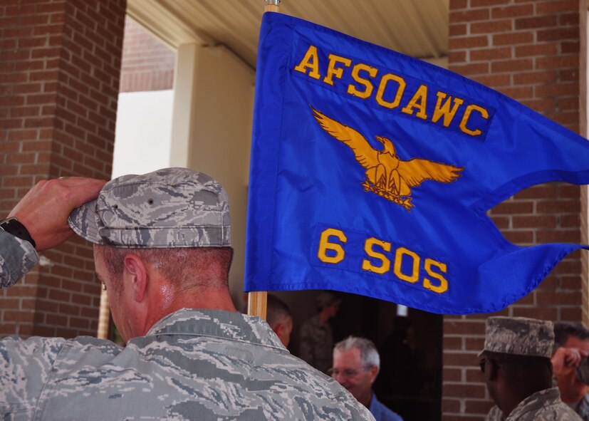 Holding his unit’s guidon, a member of the 6th Special Operations Squadron wipes sweat from his brow at Duke Field, Fla., May 28, 2013.  Moments earlier, the unit’s Airmen completed a symbolic 24.2-mile relay run to carry their guidon from their former Hurlburt Field home to their new home at Duke where they will operate as part of the Air Force Special Operations Air Warfare Center. (U.S. Air Force photo/Dan Neely)