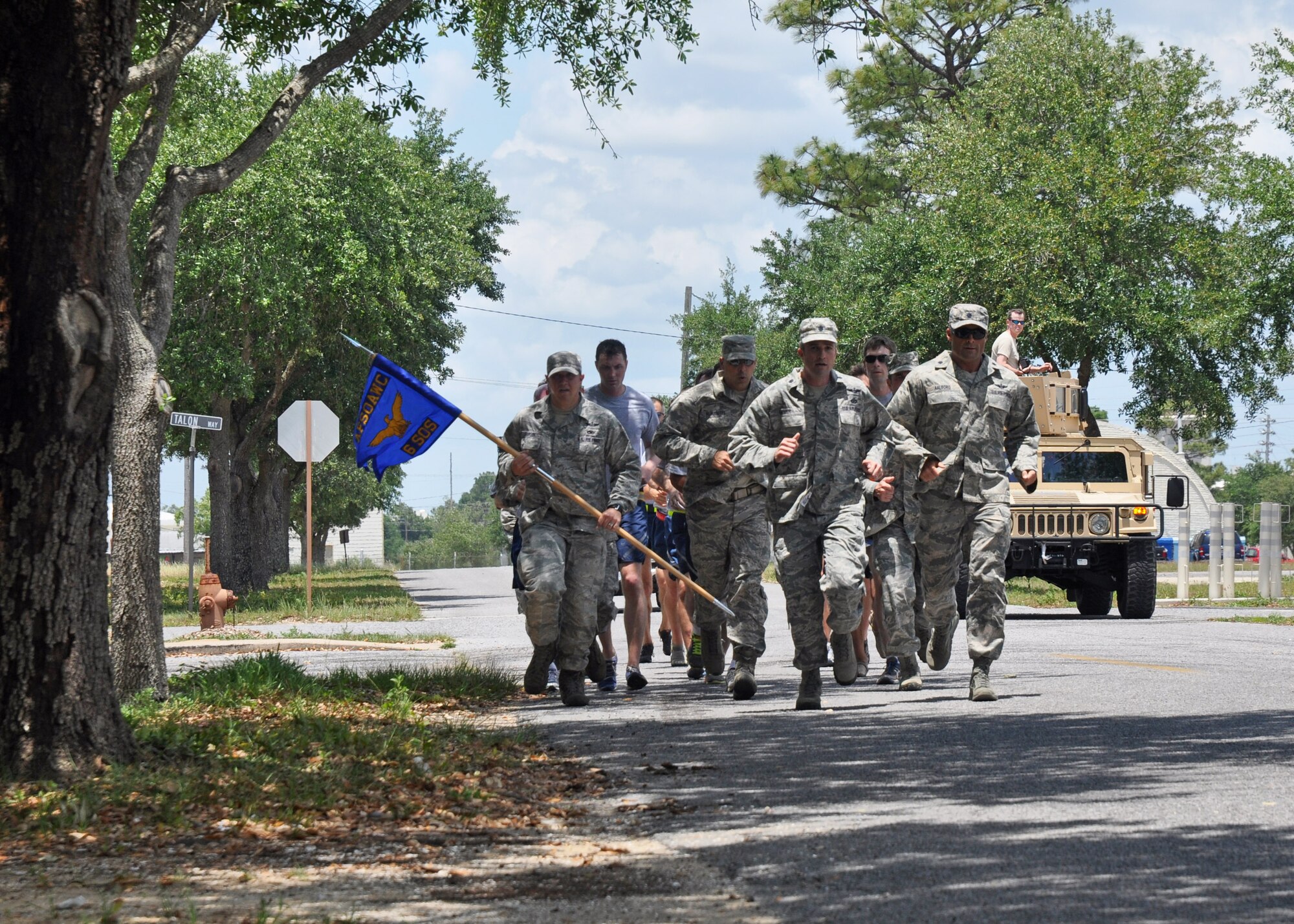 Airmen from the 6th Special Operations Squadron complete the final leg of a relay run from Hurlburt Field to Duke Field, Fla., May 28, 2013.  The 24.2-mile run symbolized the active-duty squadron’s move from Hurlburt to its new Duke Field home where it will operate as part of the Air Force Special Operations Air Warfare Center.  (U.S. Air Force photo/Dan Neely)