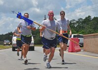 Lt. Col. Joe Michalek, from Headquarters Air Force Special Operations Command, carries the 6th Special Operations Squadron guidon as he and 6th SOS Airmen complete their 2.5-mile leg of a relay run from Hurlburt Field to Duke Field, Fla. May 28, 2013.  The 24.2-mile run symbolized the squadron’s move from its former home to its new Duke Field home where it will operate as part of the Air Force Special Operations Air Warfare Center. (U.S. Air Force photo/Dan Neely)