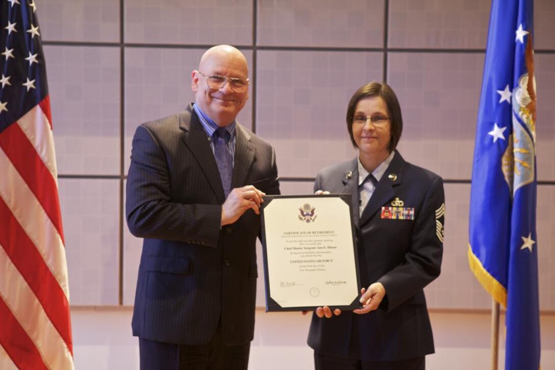 Chief Master Sgt. Ann Hinote poses with retired Air Force Col. Dennis M.
Layendecker with her Certificate of Retirement. (A.F. photo by Master Sgt.
Tara Islas)
