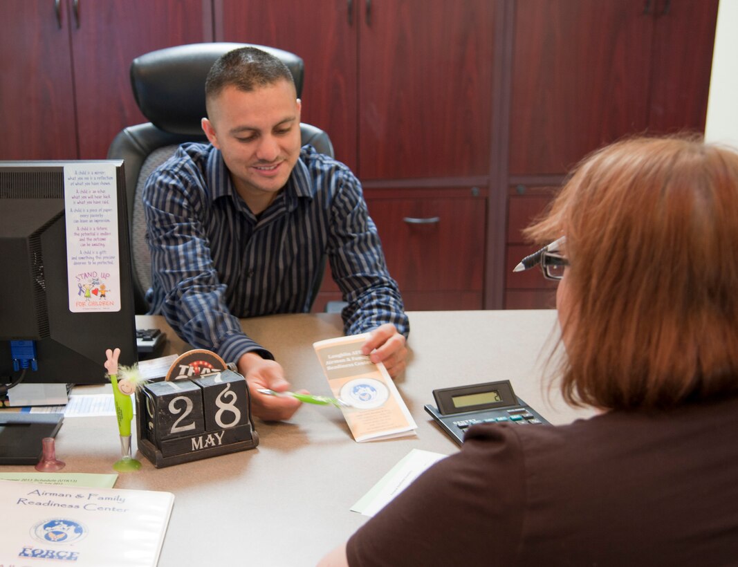 Ricardo Espinoza, 47th Force Support Squadron community readiness consultant, explains to a client some of the programs available through the Airman and Family Readiness Center at Laughlin Air Force Base, Texas, May 28, 2013. The A&FRC is offering to help government employees affected by the government mandated furloughs with financial planning assistance. (U.S. Air Force Photo/Airman 1st Class Jimmie D. Pike)