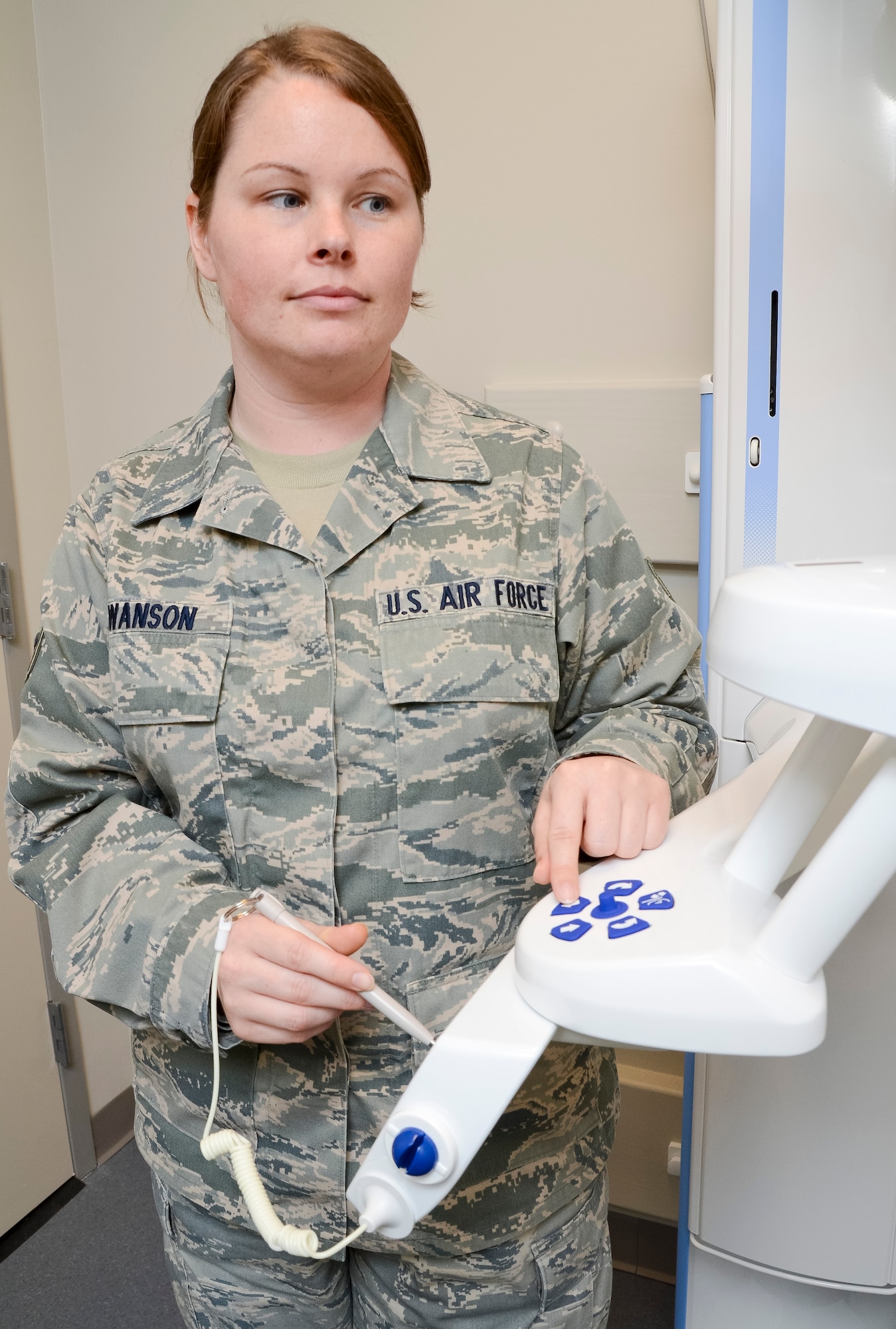 U.S. Air Force Senior Airman Meghan Swanson, a dental technician with the 116th Air Control Wing, Georgia Air National Guard (ANG), adjusts settings on a Planmeca Promax imaging unit in preparation to give dental x-rays at Robins Air Force Base, Ga., May 2, 2013.  Swanson works in the 116th Medical Group as a full-time dual-status civil service employee whose position is tied to an ANG military position.  (U.S. Air National Guard photo by Master Sgt. Roger Parsons/Released)