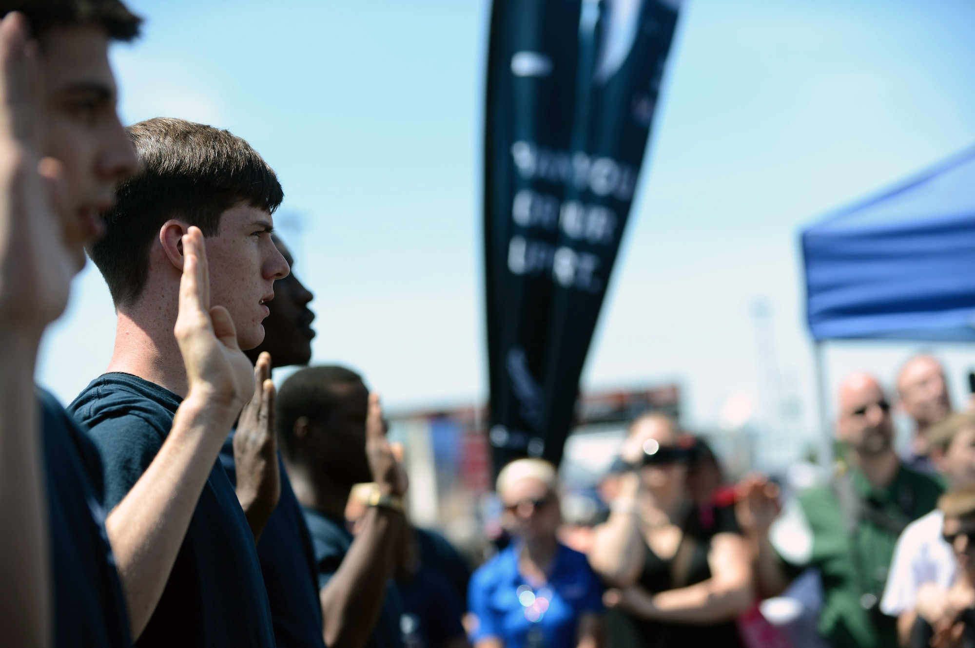 New recruits take the oath of enlistment at a NASCAR race, Charlotte, N.C., May 26, 2013.  More than 100,000 spectators attended the event in celebration of military service and to watch the NASCAR race. (U.S. Air Force photo/Airman 1st Class Nicole Sikorski)