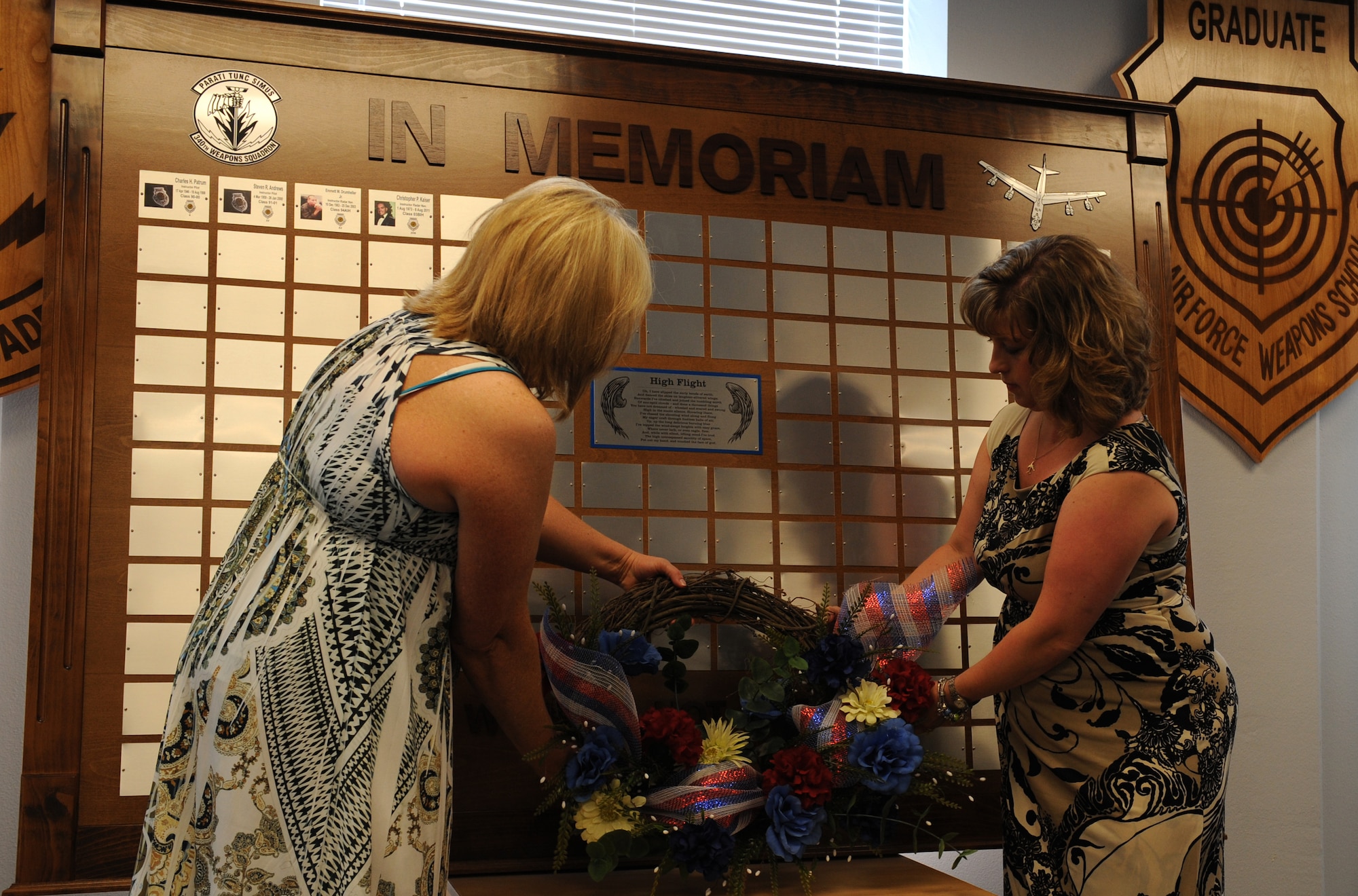The widows of Lt. Col. Emmet Drumheller, left, and Lt. Col. Christopher Kaiser, right, place a wreath in front of a plaque on Barksdale Air Force Base, La., May 26, 2013. Four deceased 340th Weapons Squadron B-52 instructor course graduates were memorialized in a ceremony. (U.S. Air Force photo/Airman 1st Class Benjamin Gonsier)
