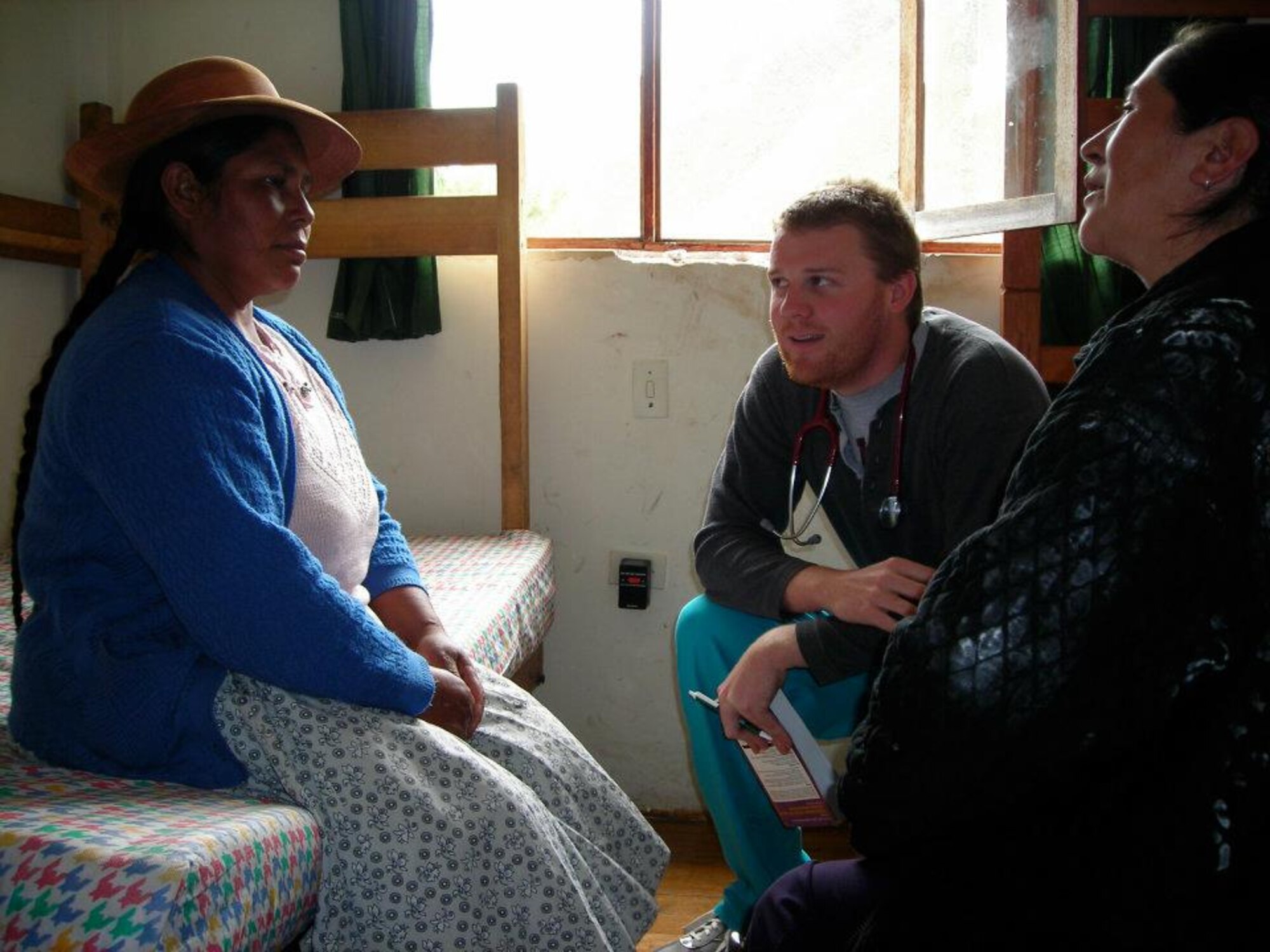 Dr. (Maj.) Nicholas Seeliger, 65th Medical Operations Squadron, speaks with Peruvian patients in the rural highlands of the Andes Mountains in Peru as part of a medical volunteer humanitarian project in 2008. On May 31, he will lead volunteers of various medical professions from Lajes Field, Azores; Eglin AFB, Fla.; Hurlburt Field, Fla.; Ramstein AB, Germany; Fort Sam Houston, Texas; and Oakland, Calif., to participate in Healing Peru by providing free medical services to many indigenous people there. (Courtesy photo)
