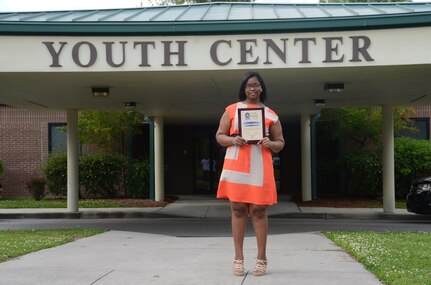 Kimberly King, 2013 South Carolina military-affiliated Boys and Girls Club Youth of the Year recipient, displays her state plaque in recognition of her achievement from earlier this May. She will compete for the Southeast regional Youth of the Year during the week of June 17. (U.S. Navy photo/ Petty Officer 1st Class Chad Hallford)