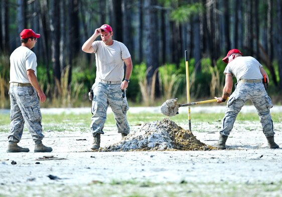 U.S. Airmen from 823rd Rapid Engineer Deployable Heavy Operational Repair Squadron Engineers, dig a hole before demolition training on Hurlburt Field, Fla., May 17, 2013. RED HORSE is known as a self-sufficient civil engineer response force capable of rapidly deploying to support contingency and special operations worldwide.  (U.S. Air Force photo/Airman 1st Class Christopher Callaway)
