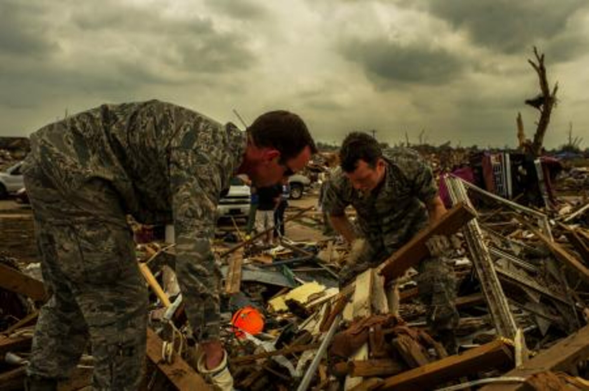 Capt. Ryan Gers, right, and Capt. Andrew Staton, left, search through the rubble, May 23, 2013, looking for anything salvageable after the devastating tornado, May 20, which damaged more than 13,000 homes in Moore, Okla. More than 600 airmen from the greater Oklahoma area volunteered to assist in the relief efforts. Gers is assigned to the 965th Airborne Air Control Squadron, Tinker Air Force Base, Okla., and hails from Scottsdale, Ariz. Staton is assigned to the 963rd AACS, Tinker AFB, and hails from Poquoson, Va. (U.S. Air Force photo by Staff Sgt. Jonathan Snyder)