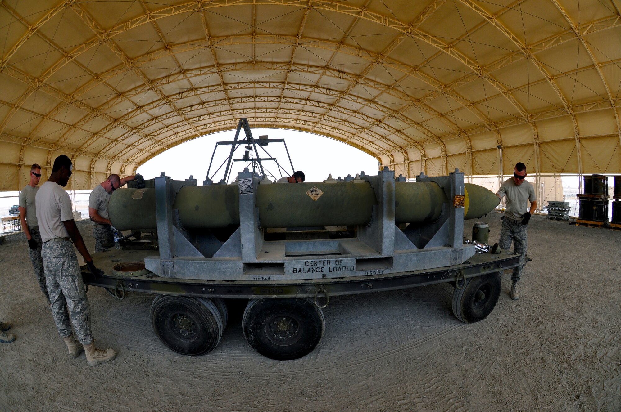The 380th Expeditionary Maintenance Squadron conventional munitions maintenance crew chiefs work on a Guided Bomb Unit-28 May 22, 2013. The GBU-28 is a 5,000 pound laser-guided conventional munition. (U.S. Air Force photo by Staff Sgt. Timothy Boyer) 