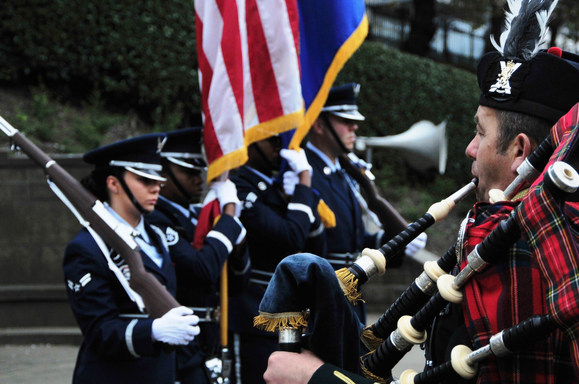 EDINBURGH, Scotland—A bagpiper from the British Army’s Royal Scots Dragoon guard plays a skirl as the 48th Fighter Wing Honor Guard stands at attention during the 79th Scottish American Memorial Day Service at the West Princes Street Gardens May 27, 2013.  The ceremony takes place in front of “The Call” war monument, which was funded by Scots-Americans in 1927 to commemorate the Scotsmen who lost their lives during World War I. (U.S. Air Force photo by 1st Lt. Lyndsey Horn)