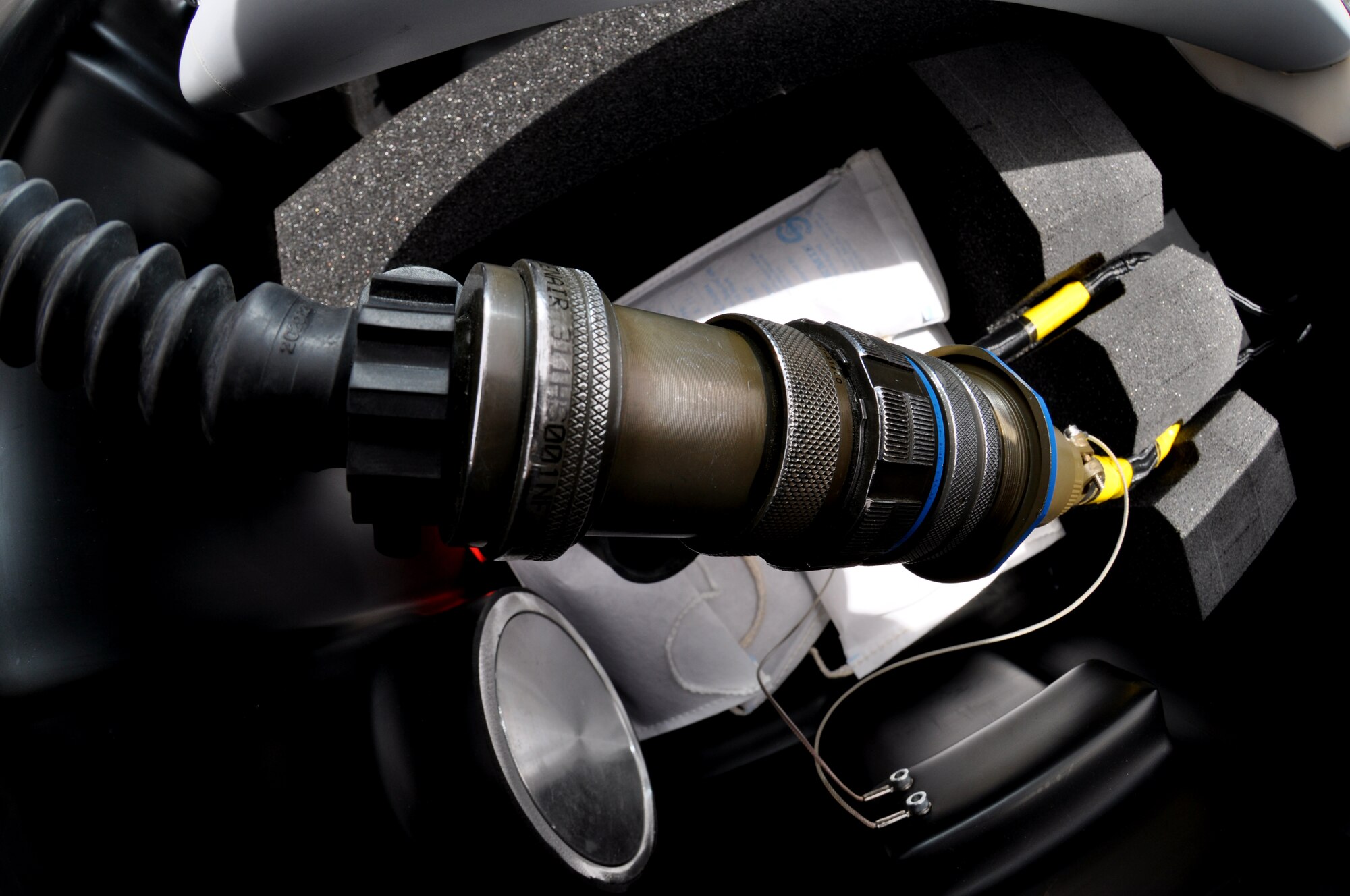 A wiring harness connects the miniature air-launch decoy non-explosive bombs to a digital test set May 22, 2013, in order to accomplish a software update to the bomb. Many of the components are preset before they leave ammo and depend on careful attention to detail to ensure they are properly set. (U.S. Air Force photo by Staff Sgt. Timothy Boyer)