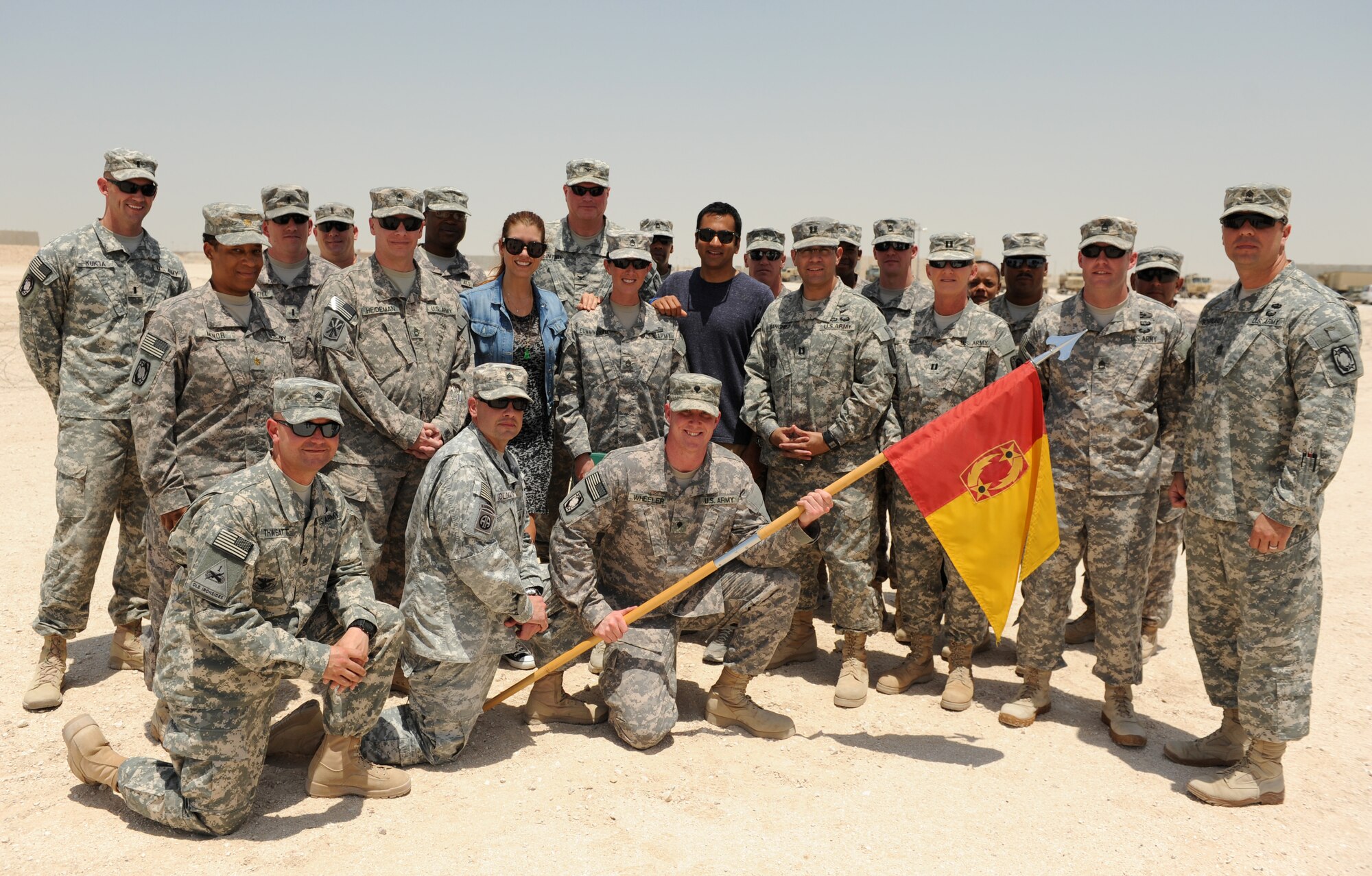 Soldiers assigned to the 69th Air Defense Artillery pose for a photo with visiting American Actors Kal Penn and Kate Walsh during their tour, May 26, 2013, at the 379th Air Expeditionary Wing in Southwest Asia. The duo were on a USO Handshake Tour with stops including the Intra-theater Care Program, a B-1B Lancer facility, military working dogs demonstration and a Patriot missile facility, as well as, a meet-and-greet at the base club. (U.S. Army photo/Capt. Steven Modugno)