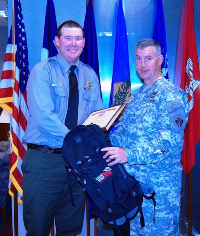 Col. Michael Teague, Tulsa District commander, presents Luke Prichard, ranger at Waurika Lake, with his graduation certificate. Walker completed the ranger training program.