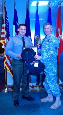 Col. Michael Teague, Tulsa District commander, presents Jake Ellison, ranger at Eufaula Lake, with his graduation certificate. Walker completed the ranger training program.