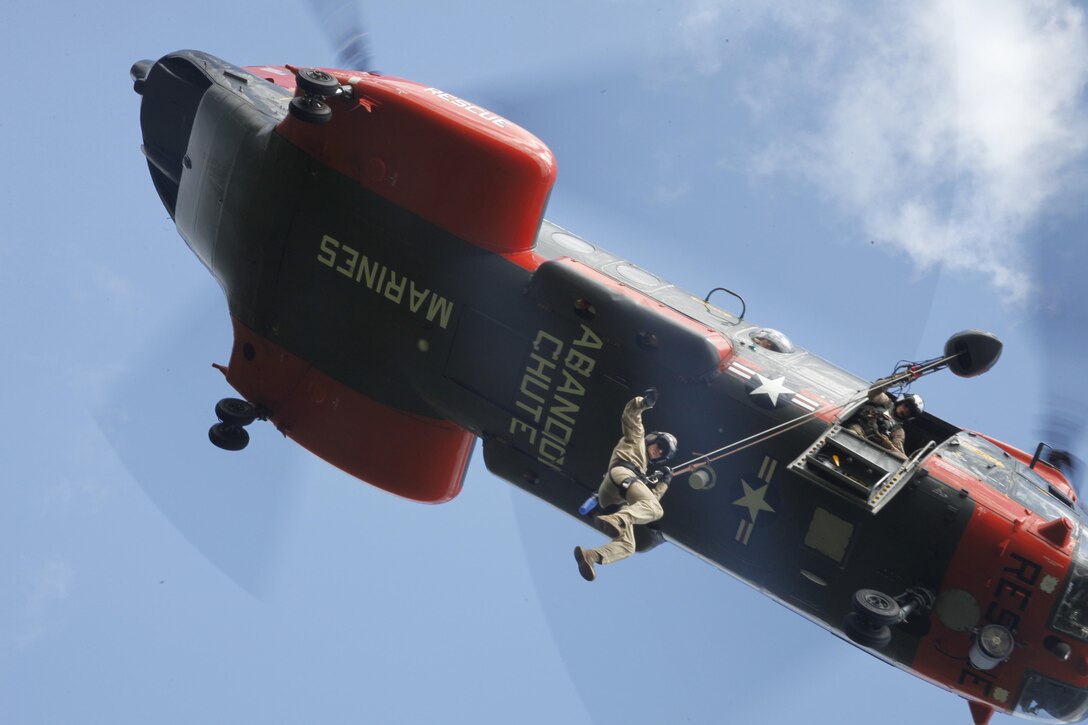 Petty Officer 1st Class Mark Mosier, a hospital corpsman with Marine
Transport Squadron 1, rappels from an HH-46E Sea Knight during a
search and rescue evaluation in the Croatan National Forest May 22.
