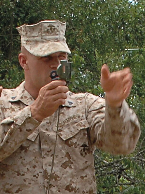 A Marine demonstrates the correct use of a compass during land navigation training at the Corporals’ Course held aboard Marine Corps Logistics Base Albany, May 12-24.