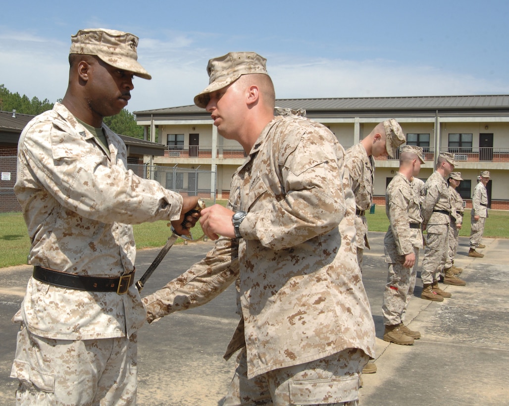 A Marine receives instruction on the proper way to removes his sword during a drill exercise at the Corporals’ Course held aboard Marine Corps Logistics Base Albany, May 12-24.