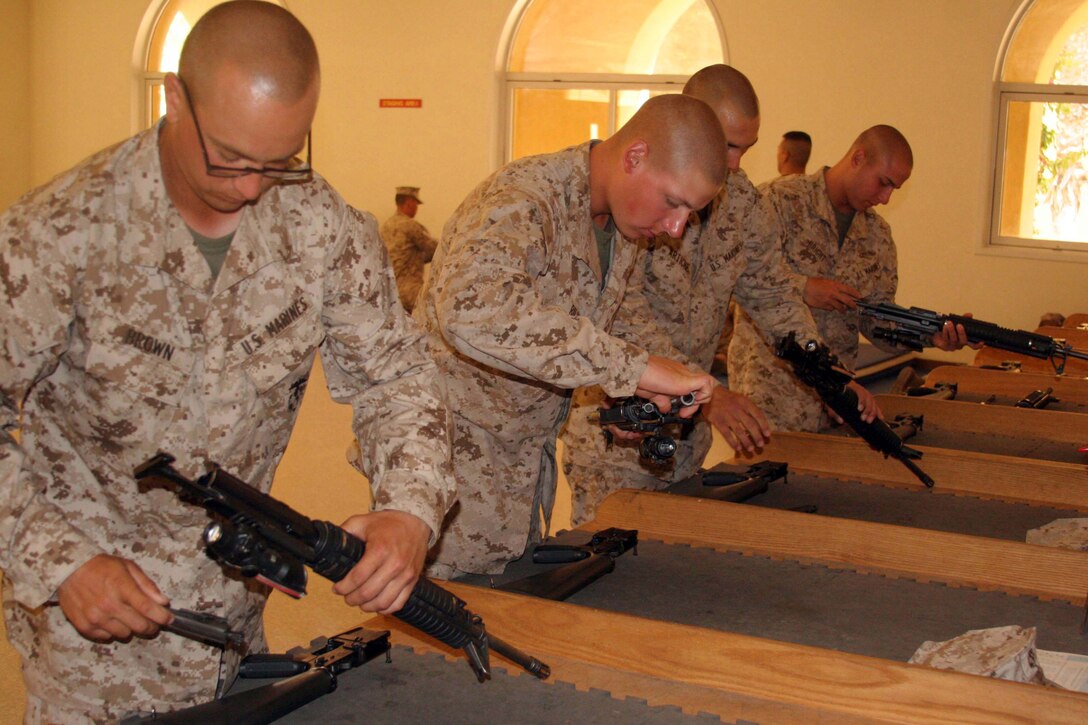 Recruits of Company A, 1st Recruit Training Battalion, perform a function check on an M16-A4 service rifle during the practical application test aboard Marine Corps Recruit Depot San Diego, May 21. Recruits must know how to properly assemble and reassemble the weapon and complete a function check to ensure it can properly fire.(U.S. Marine Corps photo by Lance Cpl. Pedro Cardenas/ Released)