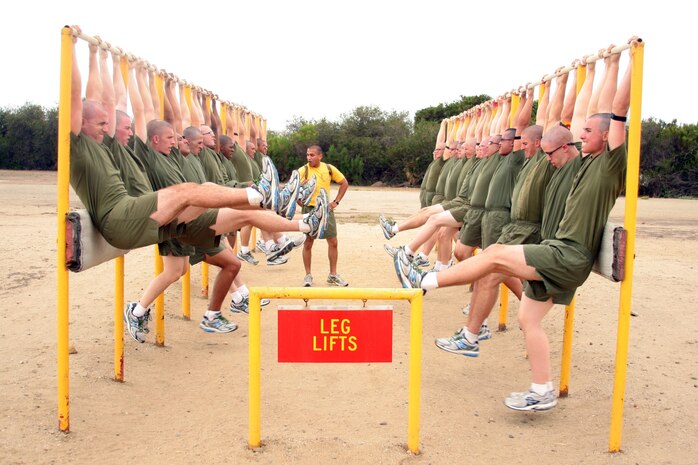 Recruits of Company E, 2nd Recruit Training Battalion perform leg lifts during the Circuit Course aboard Marine Corps Recruit Depot San Diego, May 23. Recruits must push hard in every exercise in order to achieve high levels of strength and endurance. (USMC photo by Lance Cpl. Pedro Cardenas/Released)