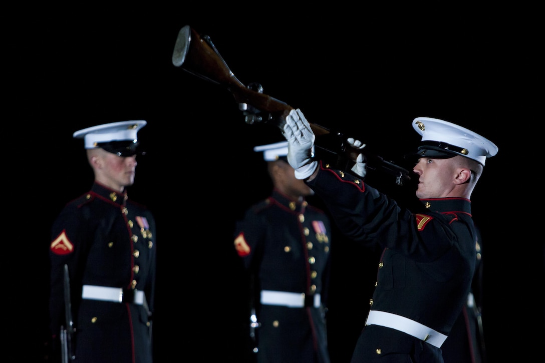 Lance Cpl. Sean Breheny, a Marine Corps Silent Drill Platoon rifle inspector, inspects an M1 Garand during a Friday Evening Parade at Marine Barracks Washington, D.C., May 24. 
