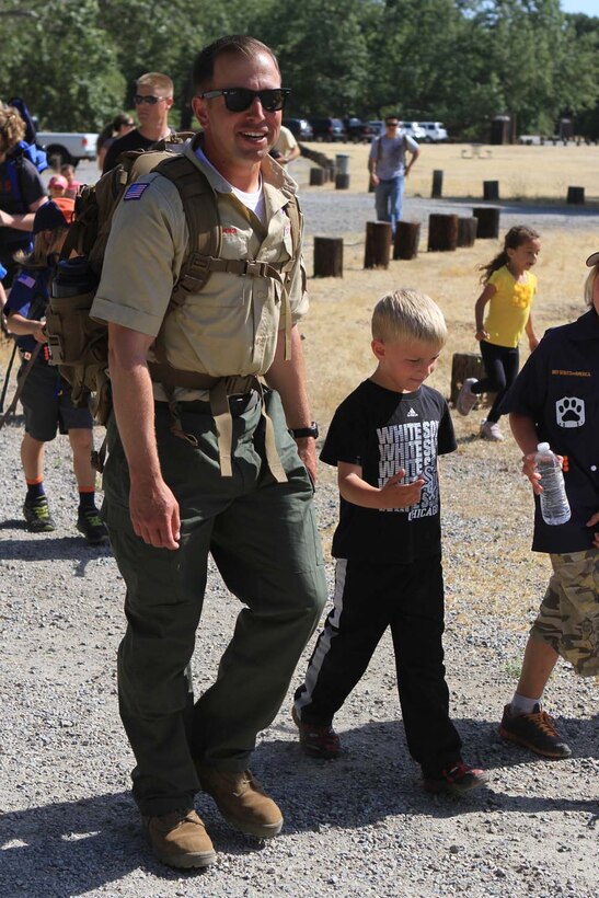 First Lt. Michael Cooley, a platoon commander serving with Mobility Assault Company, 1st Combat Engineer Battalion, walks with his son, Isaac, during a hike at Caspers Wilderness Park, Trabuco Canyon, Calif., May 18, 2013. While 1st CEB is training deploy to Afghanistan during the fall, Cooley, a native of Algonquin, Ill., devotes much of his free time to Scouting. Growing up Cooley's father was his den leader, now Cooley is a den leader for his son.