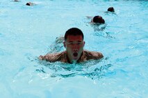 1st Lt. Stephen C. Horn participates in a basic swim qualification course May 20 at Camp Hansen during a three-day field training exercise. The basic course tests Marines' skills in the water to include treading water for four minutes, swimming 25 meters with and without a pack, and removing all equipment while under water within 10 seconds. Approximately 60 staff noncommissioned officers and officers with 3rd Marine Logistics Group completed a variety of annual training requirements during the exercise that also included gas chamber and small-arms weapons qualifications. Horn is the motor transport platoon commander with 9th Engineer Support Battalion, 3rd MLG, III Marine Expeditionary Force.