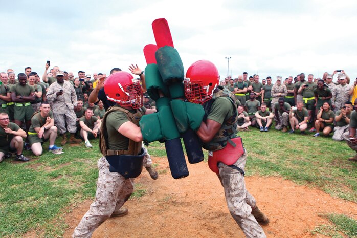 Lance Cpl. Kierston T. Broussard, left, and Pfc. Marcel O. Murray, compete in a pugil-stick bout May 24 during the 3rd Marine Logistics Group 55th anniversary celebration at Camp Kinser. "The celebration provides the opportunity to unite each regiment and battalion of 3rd MLG and rejoice in the exemplary performance of the group," said Brig. Gen. Niel E. Nelson, the commanding general of 3rd MLG, III Marine Expeditionary Force. Broussard is a radio repairman with 3rd Maintenance Battalion, 3rd MLG. Murray is a warehouse clerk with 3rd Supply Battalion, 3rd MLG.