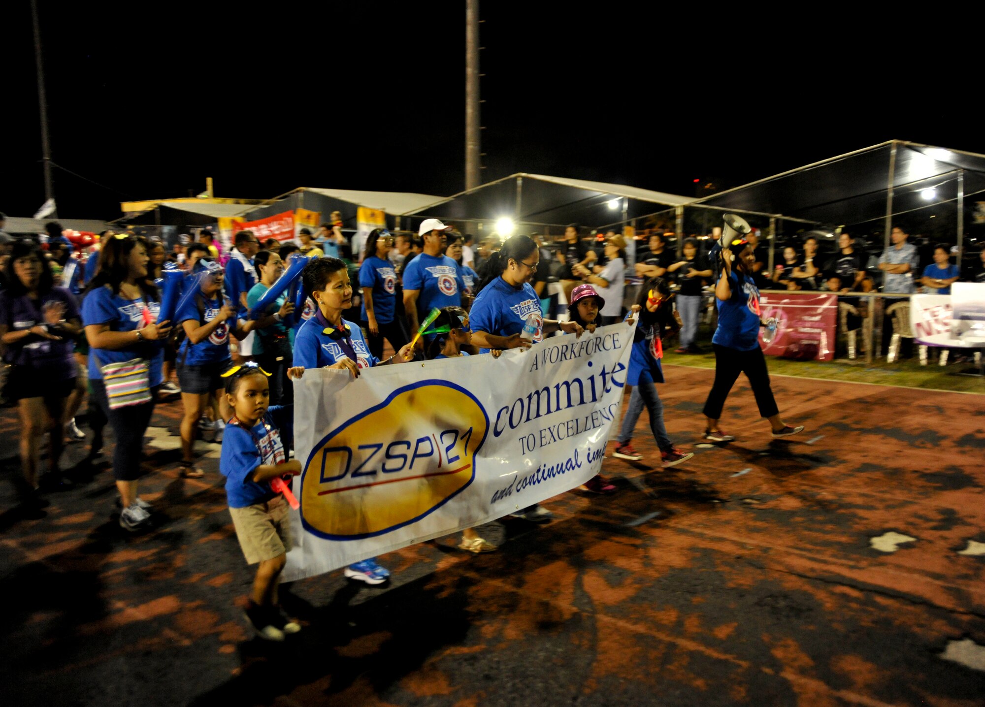 Members of DZSP-21 walk a lap during the opening ceremony of the Relay For Life event at George Washington High School, Mangilao, Guam, May 24, 2013. More than 500 people from Andersen Air Force Base and the local community participated in this year’s relay, raising $441,329.97 to help find a cure for cancer. (U.S. Air Force photo by Senior Airman Robert Hicks/Released)