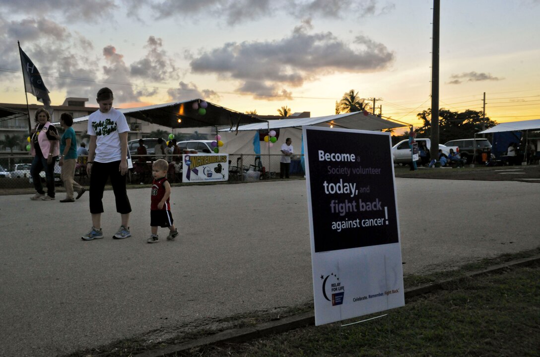 Senior Airman Heather Stoffer, 36th Wing protocol specialist, and her son walk a lap during the Relay For Life event at George Washington High School, Mangilao, Guam, May 24, 2013. Relay For Life provides an opportunity for the average person to impact the future of cancer research. More than 500 people from Andersen Air Force Base and the local community participated in this year’s relay, raising $441,329.97 to help find a cure for cancer. (U.S. Air Force photo by Senior Airman Robert Hicks/Released)