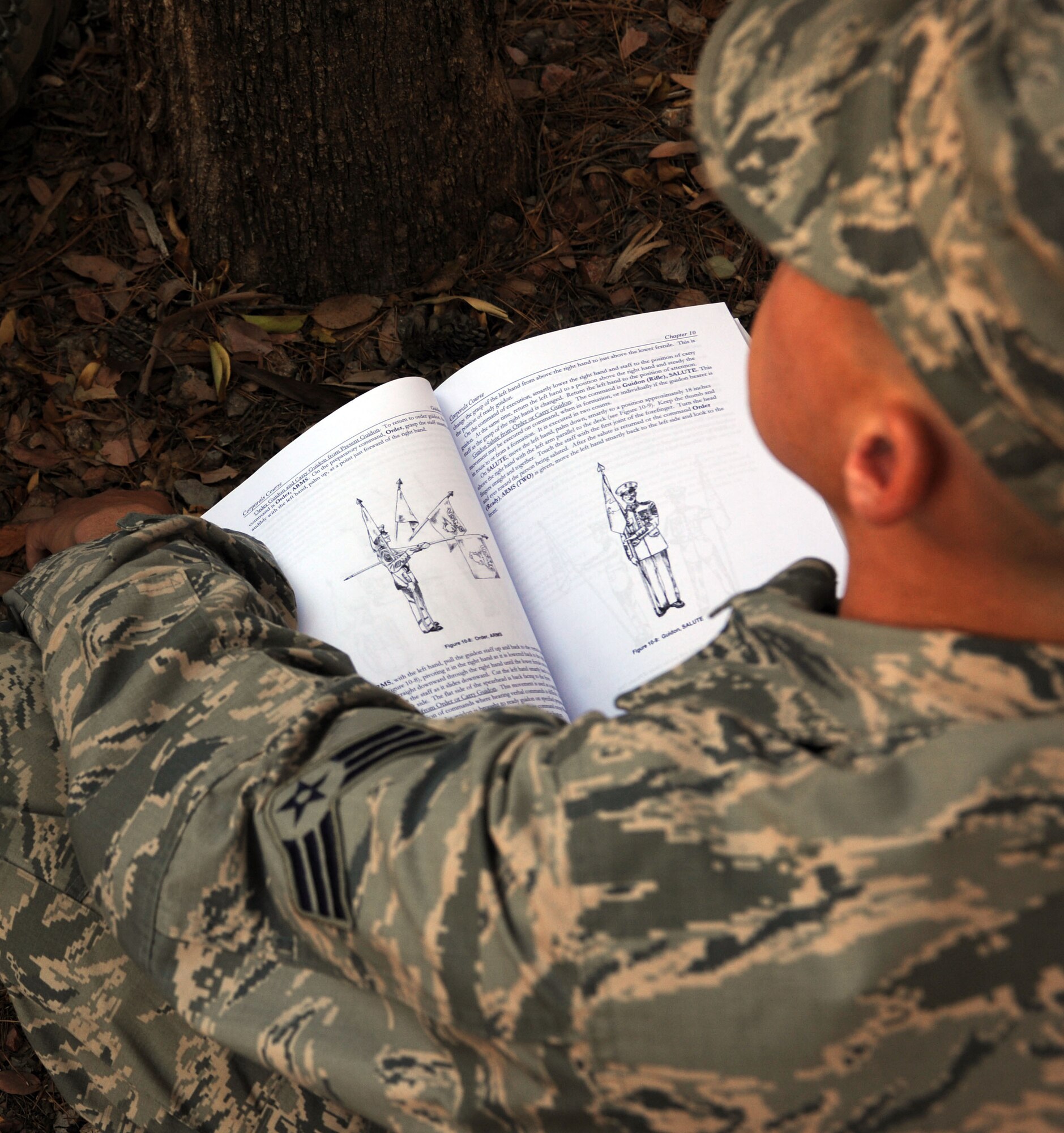 A U.S. Air Force Airmen follows along as he and his fellow students are being instructed on proper guidon techniques at Davis-Monthan Air Force Base, Ariz., May 19, 2013. Service members from three U.S. military branches participated in the U.S. Marine Corps Corporals Leadership Course at D-M.  (U.S. Air Force photo by Senior Airman Timothy Moore/Released)