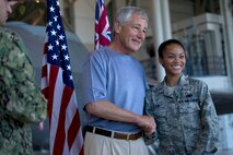 U.S. Air Force 2nd Lt. Gayleen Lim, 735th Air Mobility Squadron, receives a coin and poses for a photo with Defense Secretary Chuck Hagel May 30, 2013, inside aircraft hangar 19 on Joint Base Pearl Harbor-Hickam, Hawaii. Hagel spoke to more than 200 service members from U.S. Pacific Command, answered questions from the crowd and gave out coins thanking them for their service. During his short stop in Hawaii he also met with Pacific Command leaders before continuing to Singapore to speak at the Shangri-La Dialogue. As a senator, Hagel co-founded of the Shangri-La Dialogue, which began in 2002. This return visit to the dialogue will be his first as secretary of defense. The annual conference draws defense and security experts from across the Asia-Pacific region. Hagel’s travels will wrap up with a gathering of defense ministers at NATO headquarters in Brussels. (Department of Defense photo by U.S. Air Force Tech. Sgt. Michael R. Holzworth/Released)




