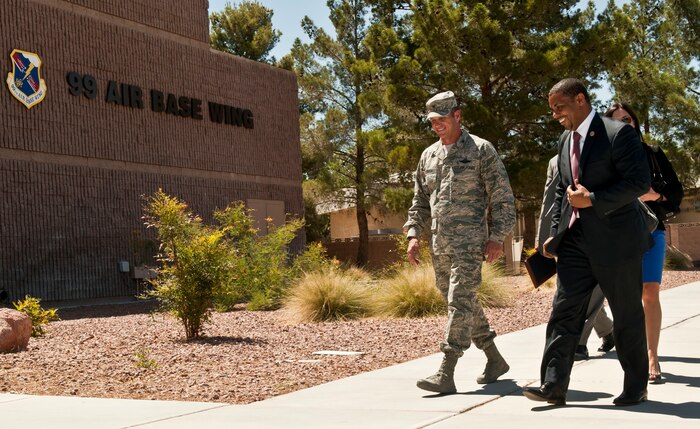 U.S. Air Force Col. Barry Cornish, 99th Air Base Wing commander, walks with Congressman Steven Horsford into the 99th ABW headquarters building during a visit May 29, 2013, at Nellis Air Force Base, Nev. Horsford is the first person to hold this House seat and the first African-American to serve in Nevada's federal delegation. (U.S. Air Force photo by Senior Airman Daniel Hughes)