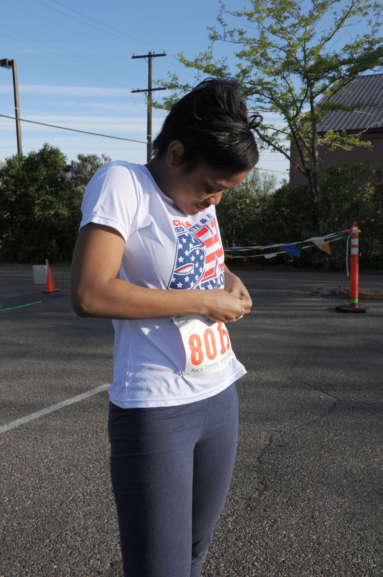 Airman 1st Class Amanda Everington, 10th Missile Squadron food service apprentice, attaches her bib in preparation for Scheel’s first ever Red White and Blue 5K and duathlon in Great Falls on May 25. Everington competed in the 5K portion and finished in third place in the females ages 20 to 29 category. (U.S. Air Force photo/Airman 1st Class Katrina Heikkinen)
